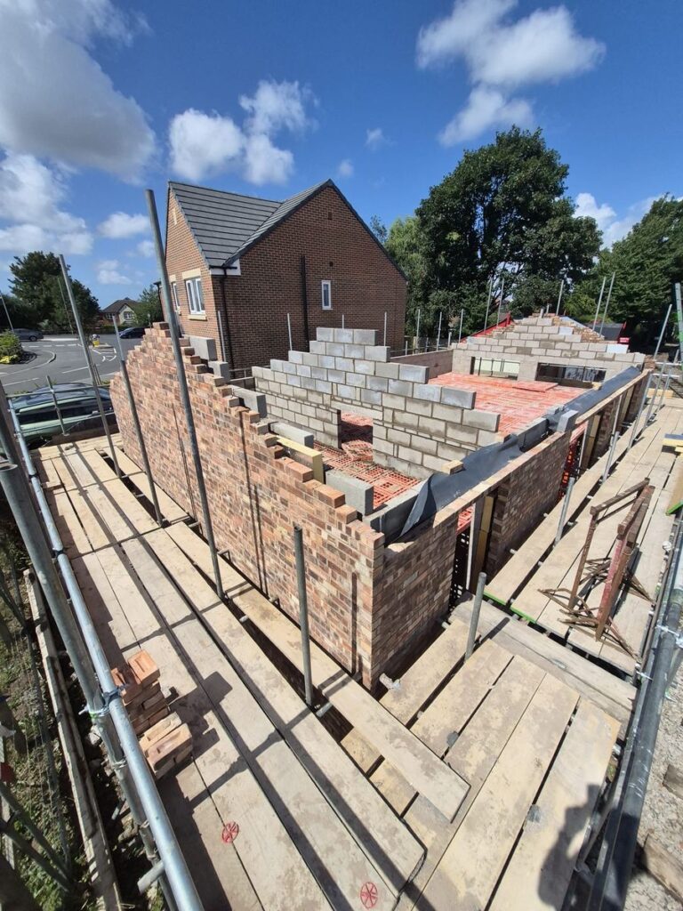New-build brickwork in progress with scaffolding in place