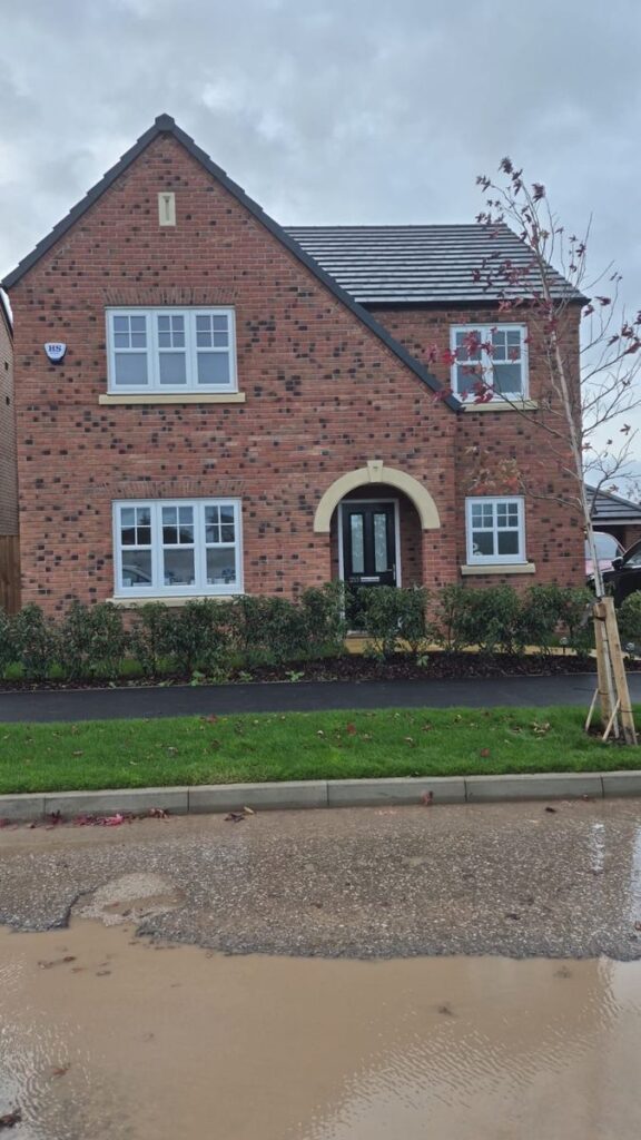New-build house with a brick arch porch