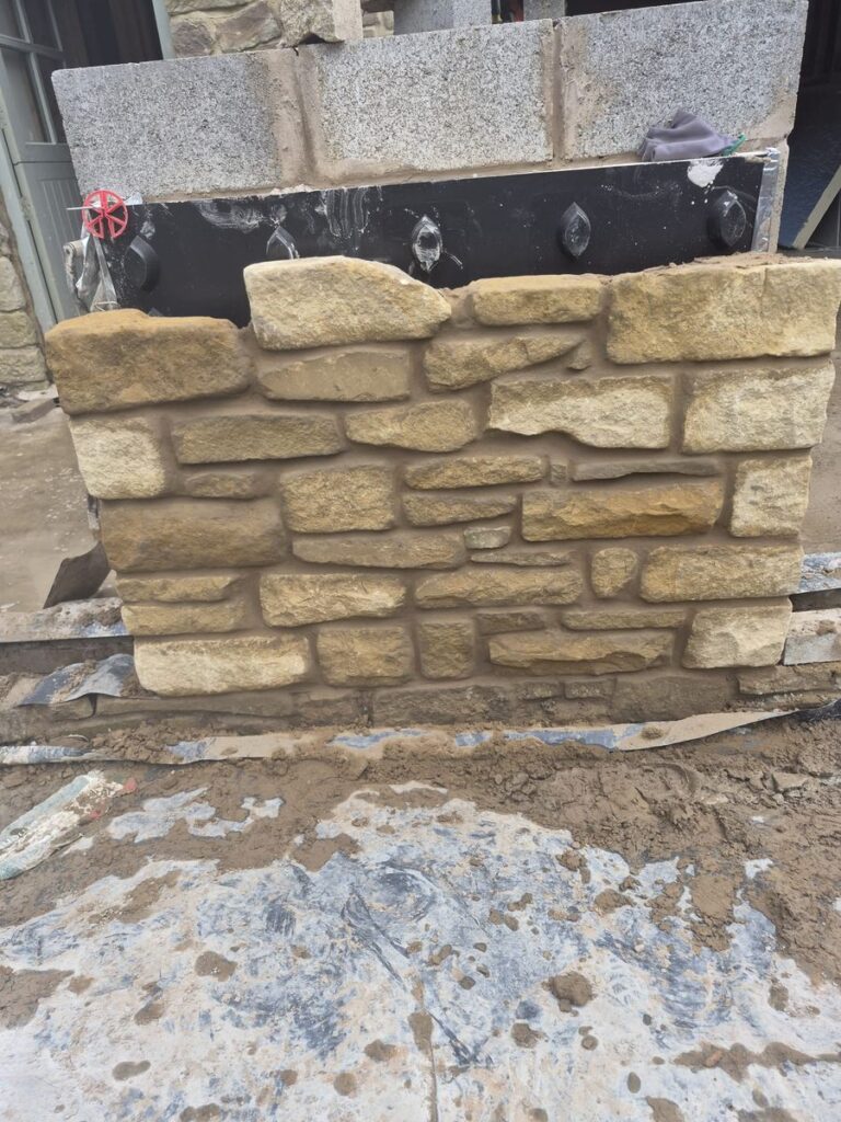 Natural stone masonry wall built by J&L Construction